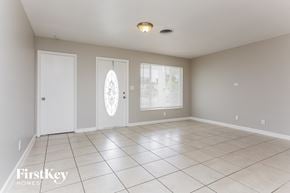 Lauderdale Lakes house for rent - a living room with a tiled floor and two doors