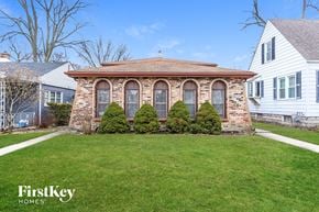 Lansing house for rent - a small brick home with a gazebo on the front yard