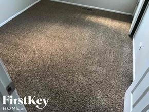 Midlothian house for rent - a carpeted floor in a room with a white door