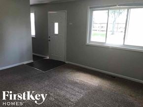 Midlothian house for rent - a carpeted room with a white door and a window