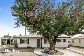 Phoenix house for rent - a small white house with a tree in front of it