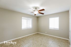 Phoenix house for rent - a bedroom with a ceiling fan and a tiled floor