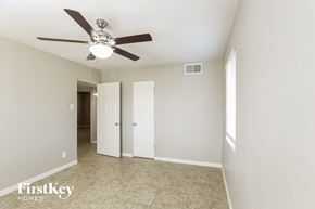 Phoenix house for rent - a living room with a ceiling fan and a door to a hallway