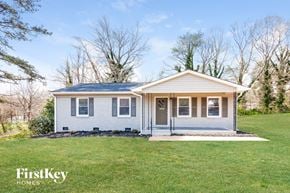 Gastonia house for rent - a small white house with a lawn and trees