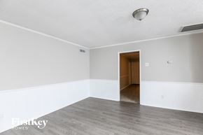 Garland house for rent - A room with a wooden door and a white wall.