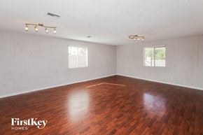Phoenix house for rent - the living room of an empty house with wood floors