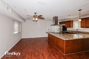 Phoenix house for rent - an empty kitchen with an island and a ceiling fan