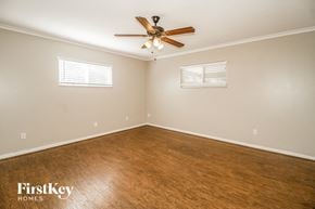 Apopka house for rent - a bedroom with a ceiling fan and a wood floor