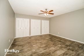 Apopka house for rent - a living room with a ceiling fan and a closet