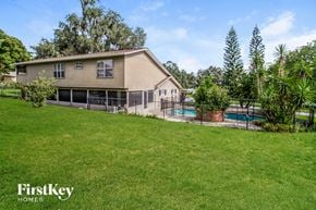Apopka house for rent - a backyard with a pool and a house