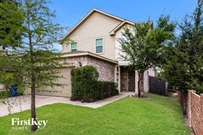 Dallas house for rent - a home with a lawn and a sidewalk in front of it