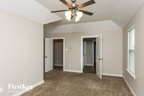 Dallas house for rent - a living room with a ceiling fan and a door to a hallway