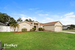 Lakeland house for rent - A house with a lawn in front of it and the words "FirstKey Homes" on the bottom left.
