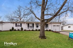 Florissant house for rent - a white house with a tree in front of it