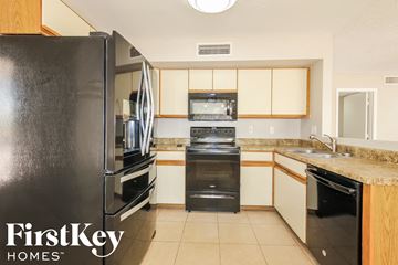 Glendale house for rent - a kitchen with stainless steel appliances and white cabinets