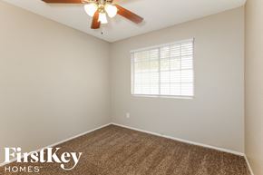Glendale house for rent - the bedroom has a ceiling fan and beige carpet and a window