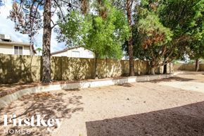 Glendale house for rent - a backyard with a retaining wall and trees