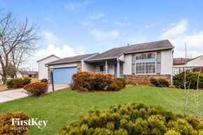 Indianapolis house for rent - A house with a blue garage door is for sale by FirstKey Homes.