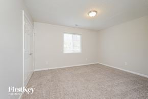 High Point house for rent - a spacious bedroom with carpet and a door to the bathroom