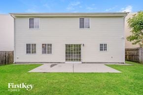 High Point house for rent - the front of a white house with a yard and grass