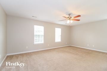 High Point house for rent - a living room with carpet and a ceiling fan