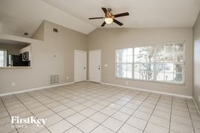 Davenport house for rent - an empty living room with a ceiling fan and a window