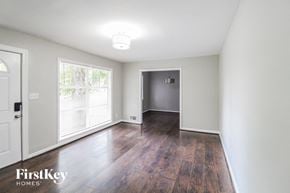 Decatur house for rent - an empty living room with white walls and wood floors