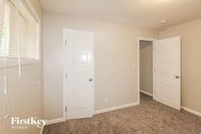 Decatur house for rent - a bedroom with two white doors and a closet