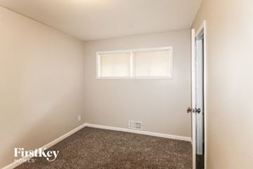 Decatur house for rent - the living room of a home with carpet and a window