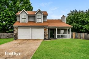Memphis house for rent - A house with a brown roof and a garage door.