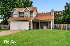 Memphis house for rent - A house with a brown roof and a garage door is for sale.