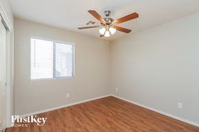 San Tan Valley house for rent - a bedroom with a ceiling fan and a window