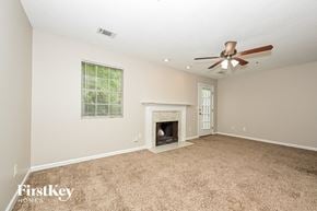 Decatur house for rent - the living room has a fireplace and a ceiling fan