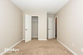 Decatur house for rent - a bedroom with two closet doors and a carpeted floor