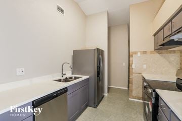Plant City house for rent - A kitchen with a stainless steel refrigerator and a sink.