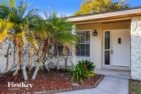 Valrico house for rent - a small house with a white door and palm trees