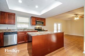 Valrico house for rent - a kitchen with wooden cabinets and a counter top