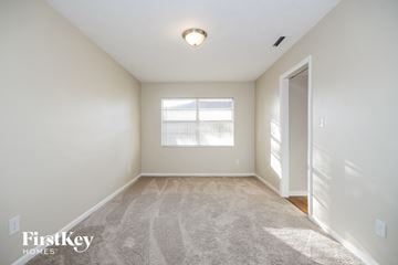 Valrico house for rent - a spacious living room with carpet and a window