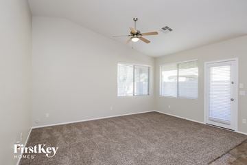 San Tan Valley house for rent - a living room with a carpet and a ceiling fan