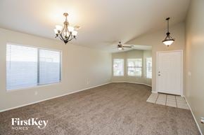 San Tan Valley house for rent - an empty dining room with a white door and ceiling fans