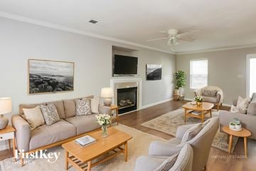 Charlotte house for rent - A living room with a grey couch, a wooden coffee table, and a painting on the wall.