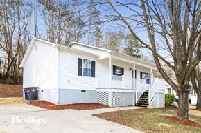 Winston-Salem house for rent - A white house with a black window and a white porch.