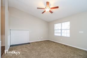 Winston-Salem house for rent - A room with a ceiling fan and a window.