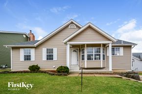 Saint Charles house for rent - a beige house with white doors and a lawn