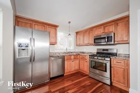 Saint Charles house for rent - a kitchen with wooden cabinets and stainless steel appliances