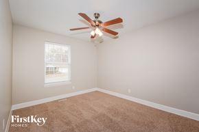 Saint Charles house for rent - a bedroom with a ceiling fan and a carpet