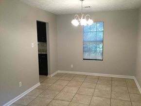 Ellenwood house for rent - A room with a window and a chandelier.