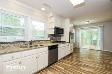 Powder Springs house for rent - a kitchen with white cabinets and a counter top