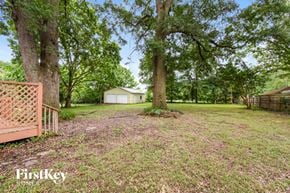 Powder Springs house for rent - a yard with trees and a house in the background