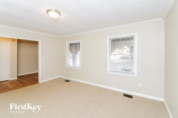 Smyrna house for rent - a living room with a rug and two windows